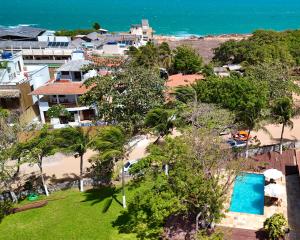 an aerial view of a resort with a pool and a beach at Chalé Heloísa Jericoacoara in Jericoacoara