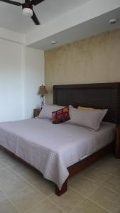 Ένα ή περισσότερα κρεβάτια σε δωμάτιο στο Condominio La Parota