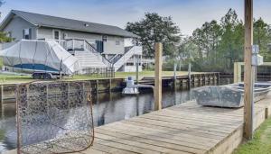 ein Boot liegt an einem Dock neben einem Haus in der Unterkunft Luxury Waterfront property in Bay Saint Louis