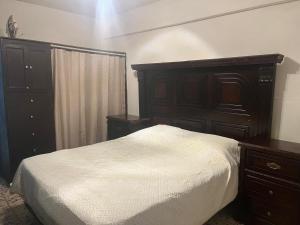 a bedroom with a bed and a wooden dresser and a bed sidx sidx sidx at Cozy and family - house Fundidora & Cintermex in Monterrey