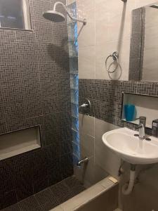 a bathroom with a sink and a shower at Cozy and family - house Fundidora & Cintermex in Monterrey