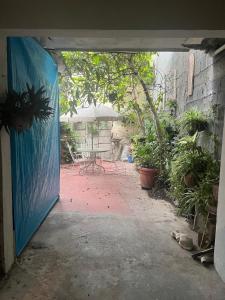 an open door to a patio with a table and plants at Cozy and family - house Fundidora & Cintermex in Monterrey
