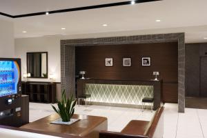 a living room with a fireplace and a tv at Hotel Vista Ebina in Ebina