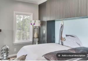 ein Schlafzimmer mit einem großen Bett und einem Fenster in der Unterkunft Luxury Waterfront property in Bay Saint Louis