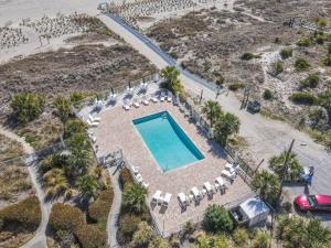 an aerial view of a swimming pool with lounge chairs and a swimming pool at Ocean Pearl in Tybee Island