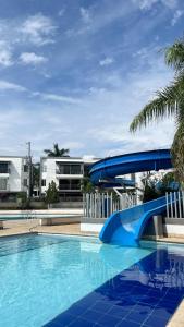 a blue water slide in a swimming pool at Hermoso Apartasol en Santa Fe de Antioquia!!! in Santa Fe de Antioquia