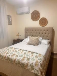 a bedroom with a large bed with a pineapple bedspread at El descanso in Higuey