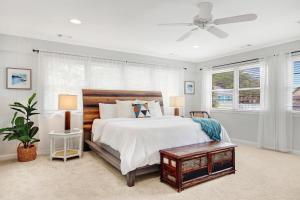 Un dormitorio con una cama y un ventilador de techo. en The Big Tybreezy, en Tybee Island 45 fotos más