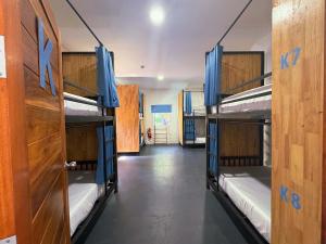 a room with three bunk beds in a room at Think Koh Tao in Koh Tao