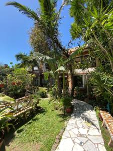 a garden with palm trees and a walkway at Garden! in Villa Ballester