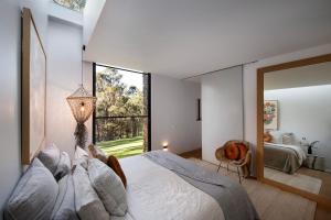 a bedroom with a large bed and a large window at Gabion Hill in Glenlyon