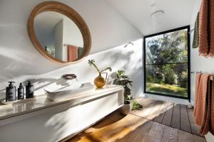 a bathroom with a sink and a mirror at Gabion Hill in Glenlyon +16 photos
