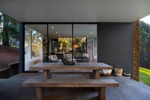 a wooden bench on the deck of a house at Gabion Hill in Glenlyon