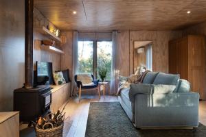 a living room with a couch and a television at Gabion Hill in Glenlyon
