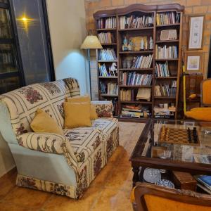 a living room with a couch and a chess board at San Cosme y Damian Lodge & Spa in San Cosme y Damián