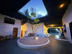 a courtyard with a tree in the middle of a building at Think Koh Tao in Koh Tao