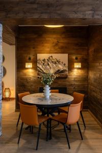 a dining room with a table and chairs at NEO Skyview Suites in Gudauri