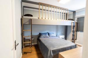 a bedroom with a bunk bed with a ladder at Seu apê de férias - Praia Grande in Praia Grande +28 photos