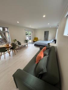 a living room with a couch and a bed at Whangapoua retreat in Whangapoua
