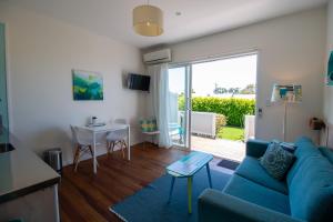 a living room with a blue couch and a table at Leigh Central in Leigh