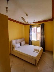 Ένα ή περισσότερα κρεβάτια σε δωμάτιο στο VITU FINE Homes 1