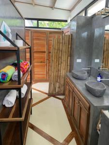 a bathroom with two sinks and a shower at Villas Isla Escondida in Boca Chica