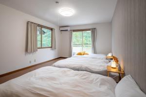 ein Schlafzimmer mit zwei Betten und einem Fenster in der Unterkunft SAKURA HOUSE - Vacation STAY 07254v in Hakone