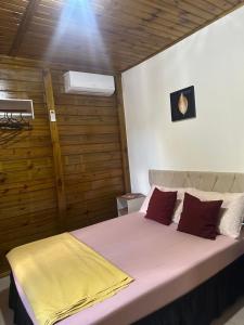 a bedroom with a bed with a yellow blanket on it at Pousada Hostels Foryou in Ibiraçu +118 photos