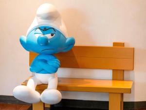 a toy elephant is sitting on a bench at Le Louise Hotel Brussels - MGallery Collection in Brussels