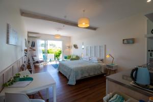 a bedroom with a bed and a living room at Leigh Central in Leigh