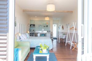 a bedroom with a bed and a living room at Leigh Central in Leigh