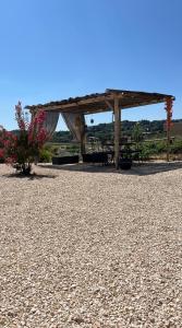 a picnic shelter with a picnic table in a park at Logement entier, Dépendance in Pézenas +5 photos