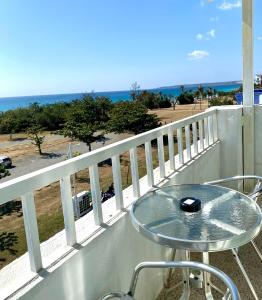 a table on a balcony with a view of the ocean at Kenting Waterfront Hotel in Kenting