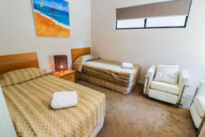 Baywatch unit 2 at 1770 في سفنتين سيفينتي: غرفة نوم بسرير وكرسي وأريكة