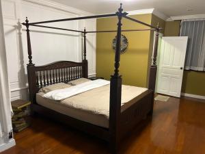 a bedroom with a canopy bed in a room at Family room in Bang Kapi