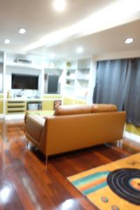 a living room with a couch and a rug at Family room in Bang Kapi