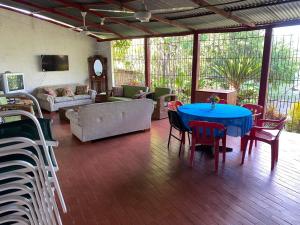 a living room with a blue table and chairs at Finca La Camila in Coello