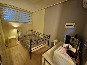 a small bedroom with a bed and a window at Bombay Residence SNU Nakseongdae Station in Seoul