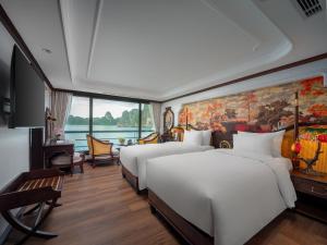 a bedroom with two beds and a painting on the wall at Lamour Cruise in Ha Long +80 photos