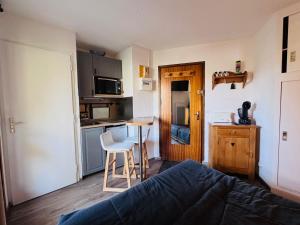 a room with a bed and a kitchen with a table at Studette cosy pour 2 aux Deux Alpes avec balcon - FR-1-546-62 in Les Deux Alpes