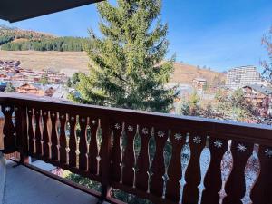 a view from a balcony with a christmas tree at Studette cosy pour 2 aux Deux Alpes avec balcon - FR-1-546-62 in Les Deux Alpes