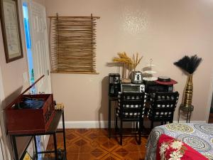 a dining room with a table and a table and chairs at Cozy home in Pompano Beach