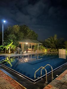 a swimming pool at night with the lights on at BAYU COVE Private Villa in Tangalle