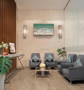 a living room with two couches and a table at Sochi Hotel in Nha Trang