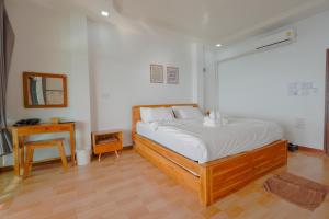 Ένα ή περισσότερα κρεβάτια σε δωμάτιο στο มาภูโฮมสเตย์