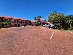 an empty parking lot in front of a building at Old Willyama Motor Inn in Broken Hill