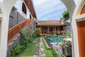 an external view of a house with a swimming pool at Kania Rooms & Suite in Seminyak