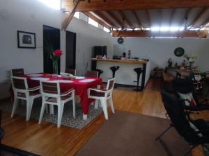 a dining room with a red table and chairs at Habitacion en Villakite ,Salinas del Rey in Juan de Acosta
