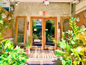 a front door of a building with plants at WiNNiNE Cozy Home in Bangkok