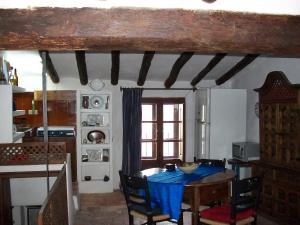 a kitchen with a table with a blue table cloth on it at Casa de la Musica in Calaceite